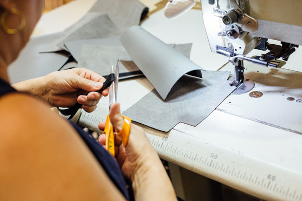  A woman cutting a piece of upholstery fabric