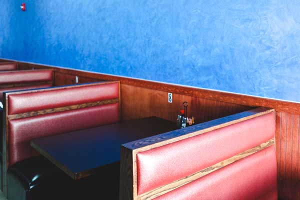 Chairs upholstered with brown colored fabric in a restaurant